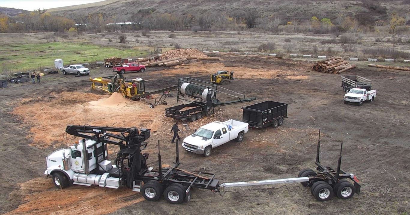 Nez Perce Tribe firewood program trucks and workers aerial view