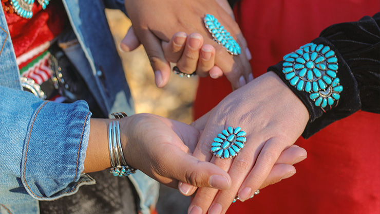 Two Native Women Hold Hands