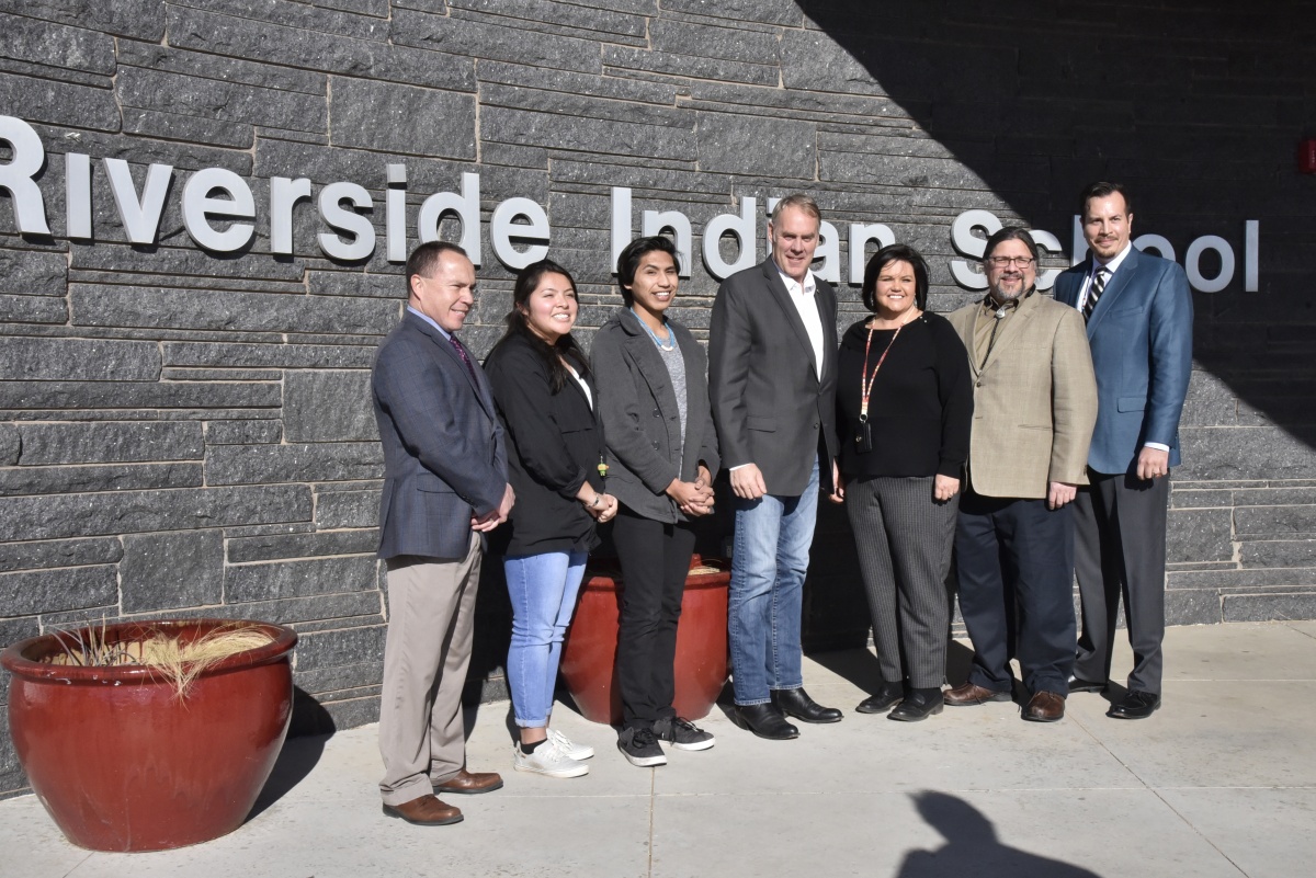 A photograph of DOI Leadership with Riverside Indian School administrators and students.
