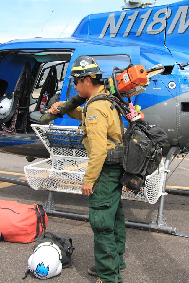 Harold Quintero prepares to load fire equipment onto one of BIA's seven contracted helicopters.