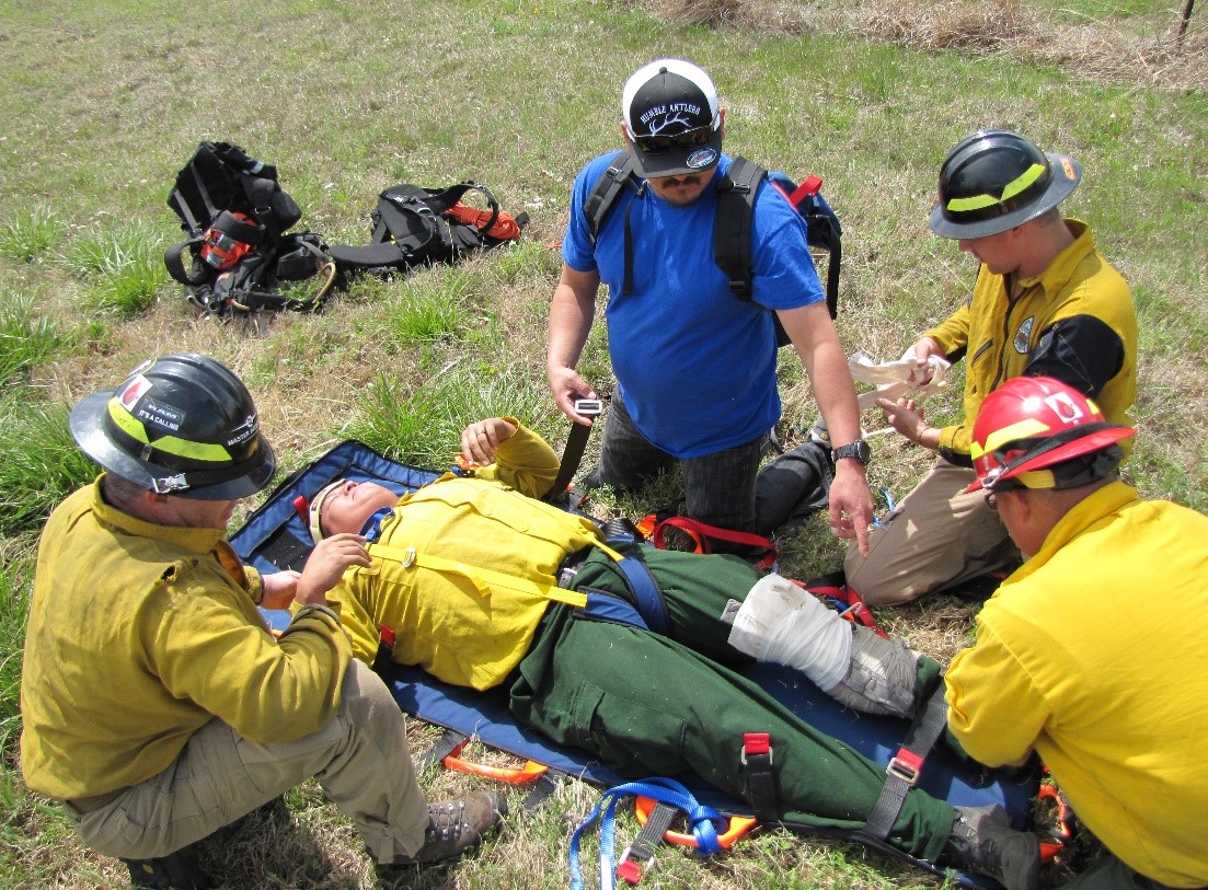 Firefighters practice giving first aid to a firefighter during a simulation in El Reno, OK. Credit: Michelle Moore, Program Coordinator