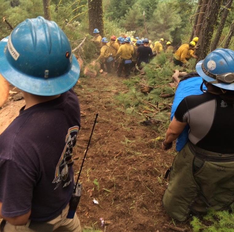 Progress of an emergency carry-out by the Navajo Interagency Hotshots. Progress of an emergency carry-out by the Navajo Interagency Hotshots. Patient #2 is moved downhill for medical transport to drop point 1. Photo: Randy Ostman, on-scene Safety Officer.