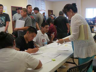 Applicants line up to see a Human Resources Specialist at 2017 job fair in San Carlos, AZ