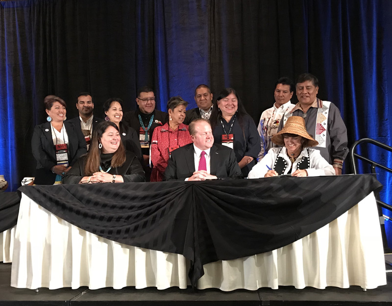 AIANTA Executive Director Camille Ferguson signing an MOU with DOI Assistant Secretary for Indian Affairs Tara Sweeney  and DOC Assistant Secretary for Legislative and Intergovernmental Affairs Michael Platt