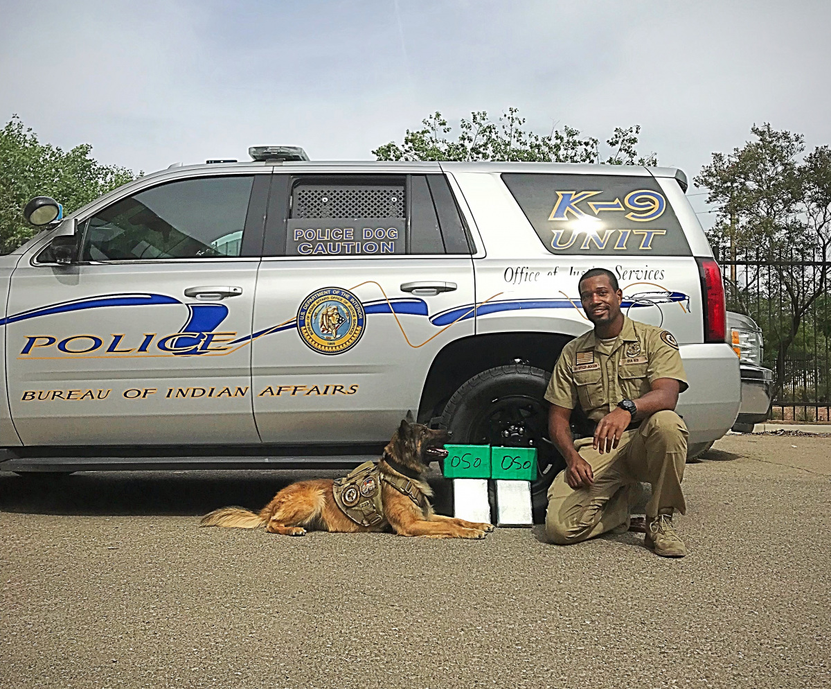 BIA Officer Jackson and K9 Kofi with seized heroin.
