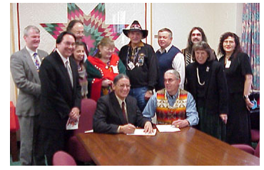 Assistant Secretary Gover, Chinook Chairman Gary Johnson, Deputy Assistant Secretary – Indian Affairs Michael Anderson, and BIA Deputy Commissioner M. Sharon Blackwell each signed the final determination for federal recognition of the Chinook Indian Tribe/Chinook Nation. Also present were Congressman Brian Baird (WA-3rd) and tribal council members. Standing Left to Right: Congressman Baird; DAS-IA Anderson; Council members Peggy Disney, Richard Basch (behind Disney), and Penny Harris; Chinook Chief Clifford