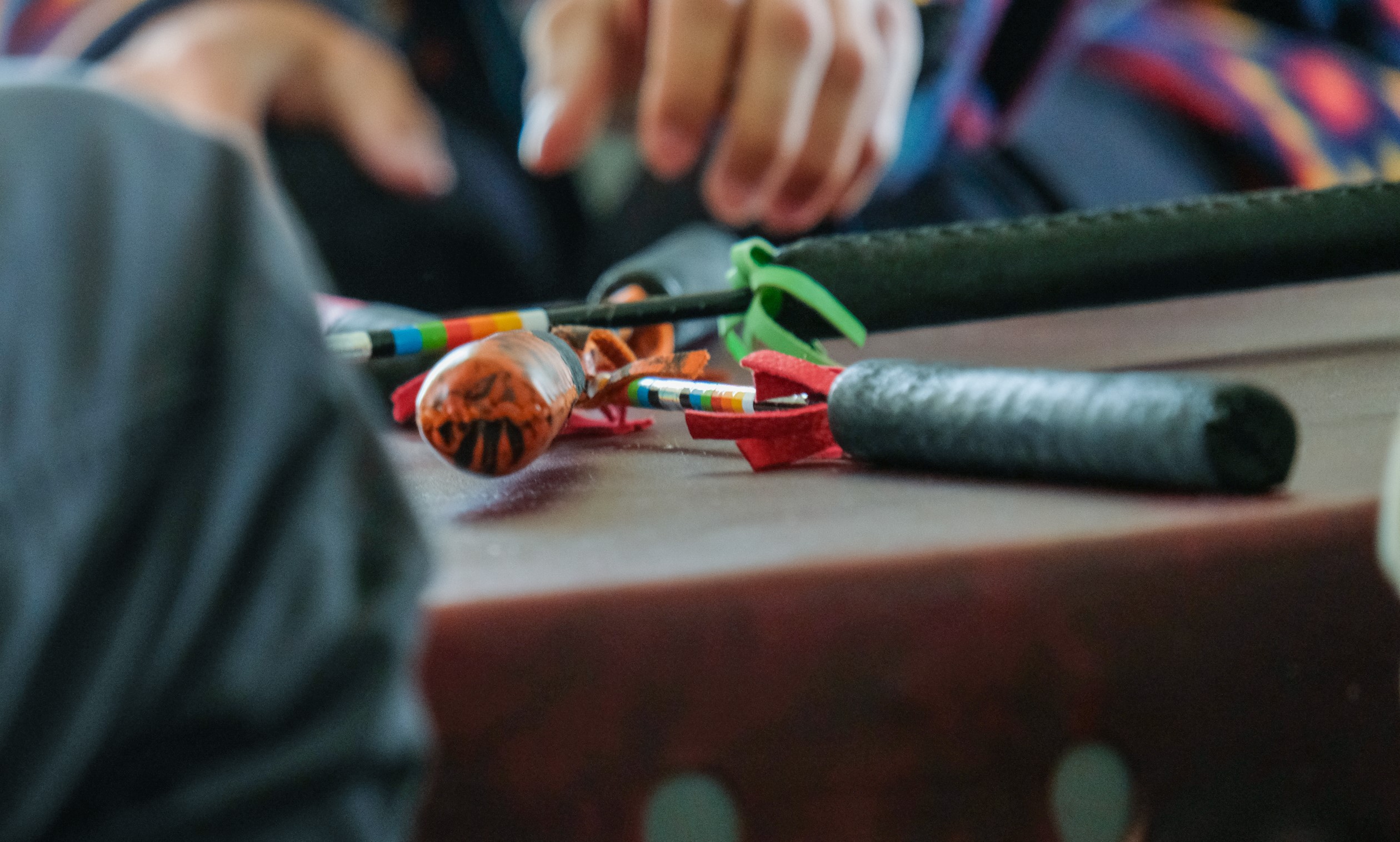 A close up photo of a drum and drum sticks crossed over the drum between songs.