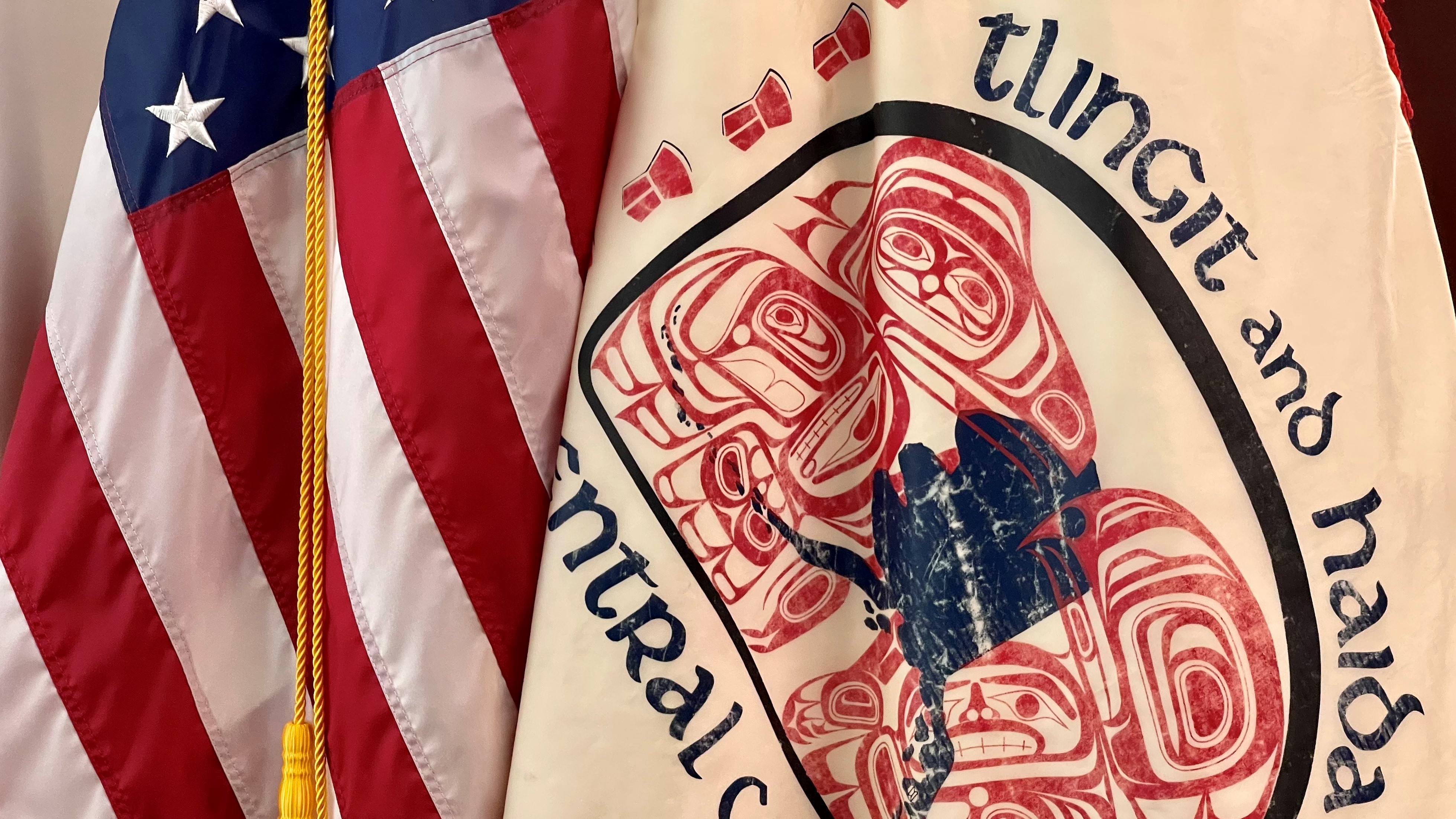 The United States and Tlingit and Haida flags The United States flag next to the Tlingit and Haida tribal flag.