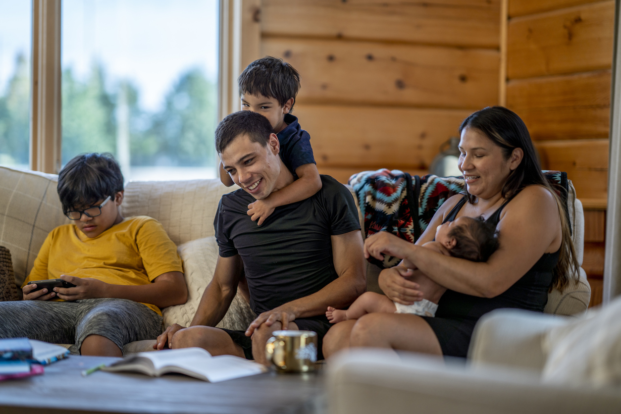 A Native American family gathering on a couch.