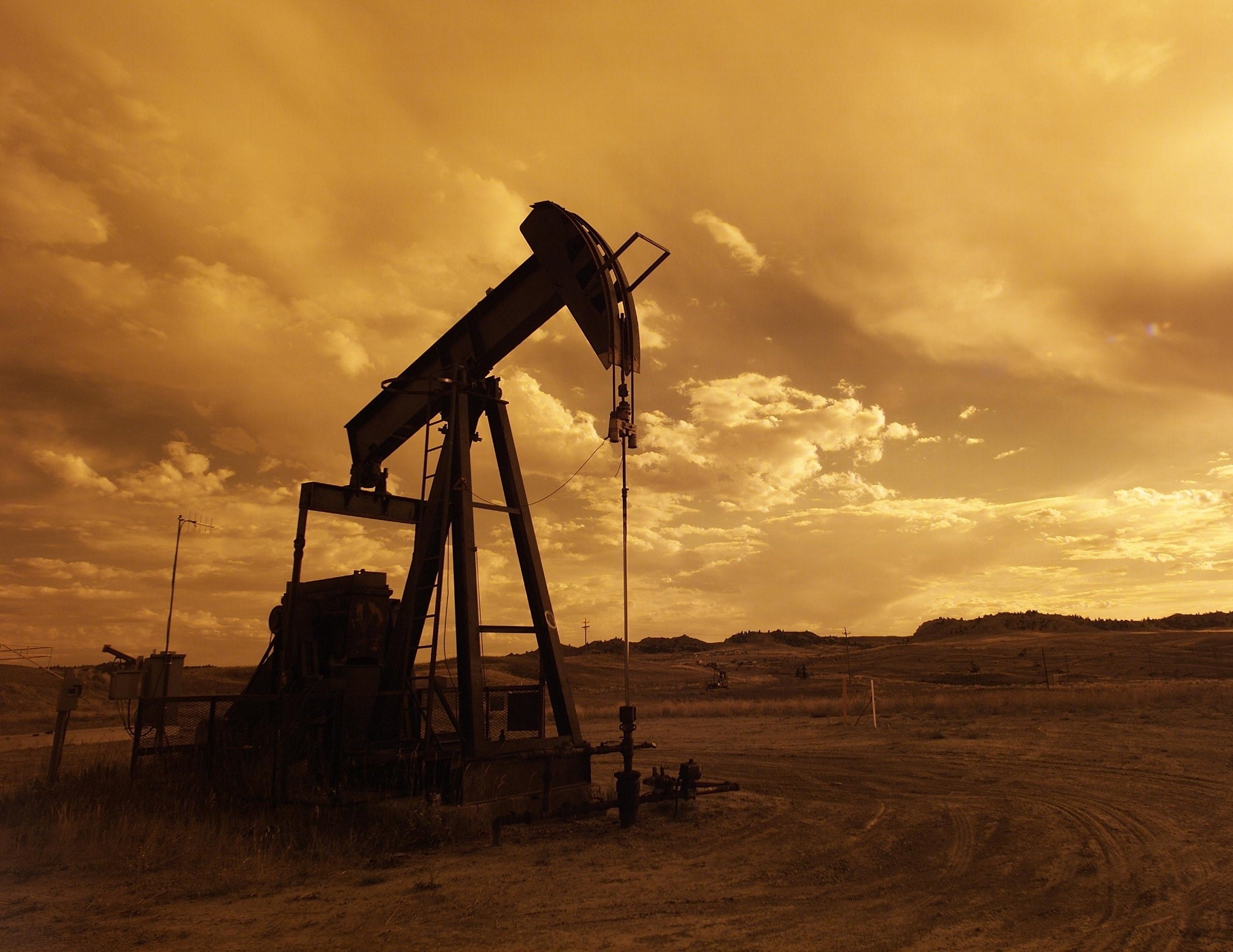 Industrial machine during golden hour in a field.