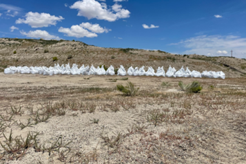 50 super sacks filled with sand staged near service spillway.