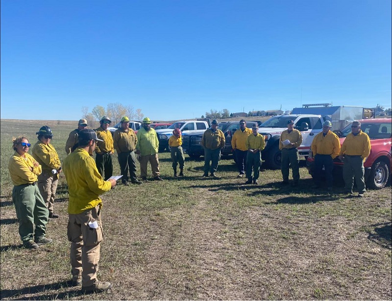 Trainees receive a briefing identifying hazards, objectives, communications, roles, and tactics before any prescription burn takes place.