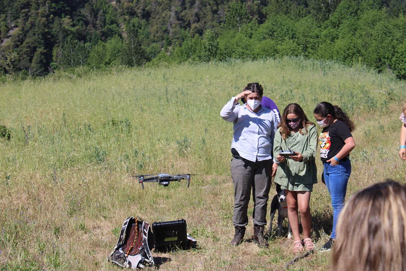 University of Washington graduate student shows students how to fly a drone.