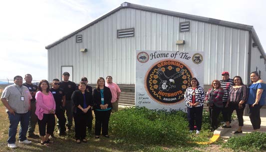 Geronimo IHC Staff gathered in front of office building.