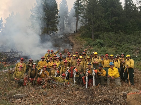 Mission Valley and BIA Oklahoma hand crews pose for a picture at the end of shift while working jointly on the Blue Bay Fire (2017), Polson MT. Credit: CSKT