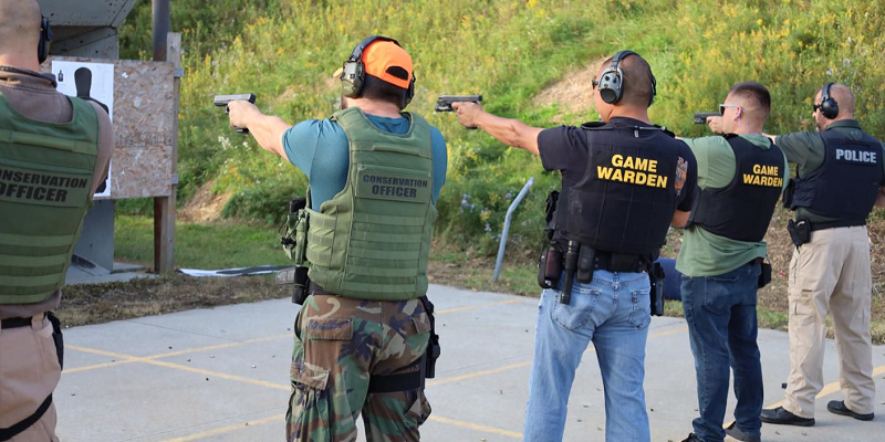 Conservation officers participating in a shooting competition at a NAFWS conference.