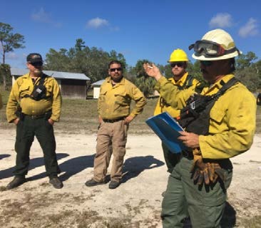 Burn boss trainee conducts off site safety briefing prior to entry into burn unit.