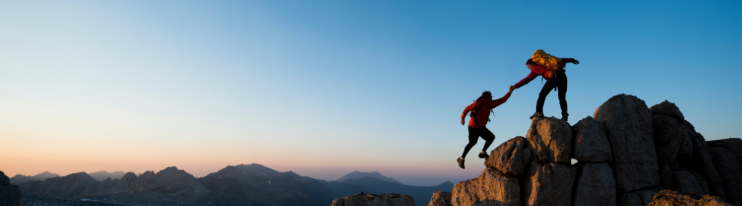 Image of mountain climbers with sunrise in background