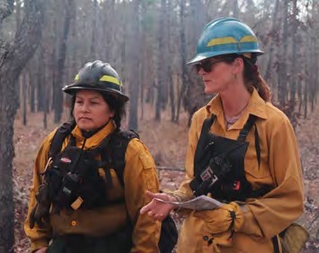 Yvette Leecy with host unit ecologist, learning about the ecology and history of the land they will burn.