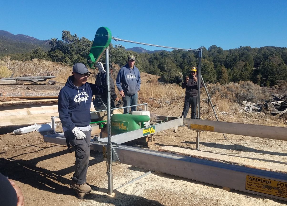 Picuris Pueblo Sawmill workers working outside