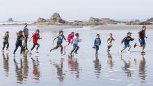 Youth Running on beach coast.