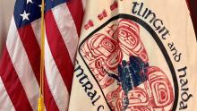 The United States and Tlingit and Haida flags The United States flag next to the Tlingit and Haida tribal flag.