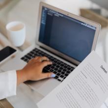 A photo of an employee digitizing a paper record toward modernizing the workplace.