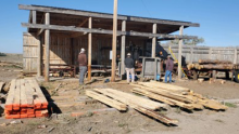Photo of BIA Timber Team visiting the Rosebud Sioux Tribal Forestry mill and watching the local staff cut ponderosa pine into boards for different projects at the Rosebud Sioux timber processing mill.