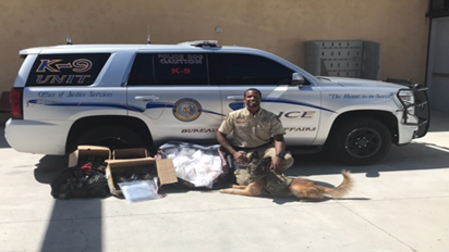 BIA Officer Jackson and K9 Kofi with seized narcotics.