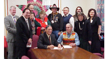 Assistant Secretary Gover, Chinook Chairman Gary Johnson, Deputy Assistant Secretary – Indian Affairs Michael Anderson, and BIA Deputy Commissioner M. Sharon Blackwell each signed the final determination for federal recognition of the Chinook Indian Tribe/Chinook Nation. Also present were Congressman Brian Baird (WA-3rd) and tribal council members. Standing Left to Right: Congressman Baird; DAS-IA Anderson; Council members Peggy Disney, Richard Basch (behind Disney), and Penny Harris; Chinook Chief Clifford