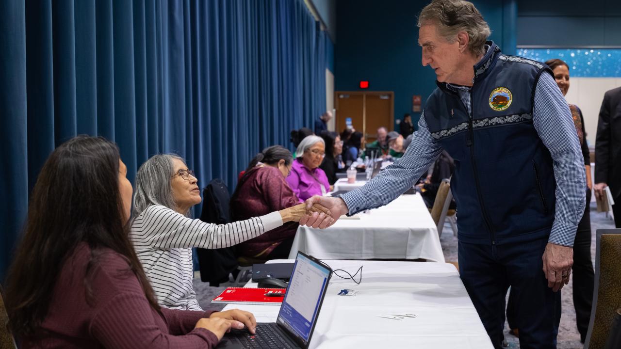 A photo of Secretary Doug Burgum shaking hands with tribal members at the probate surge in Alaska.