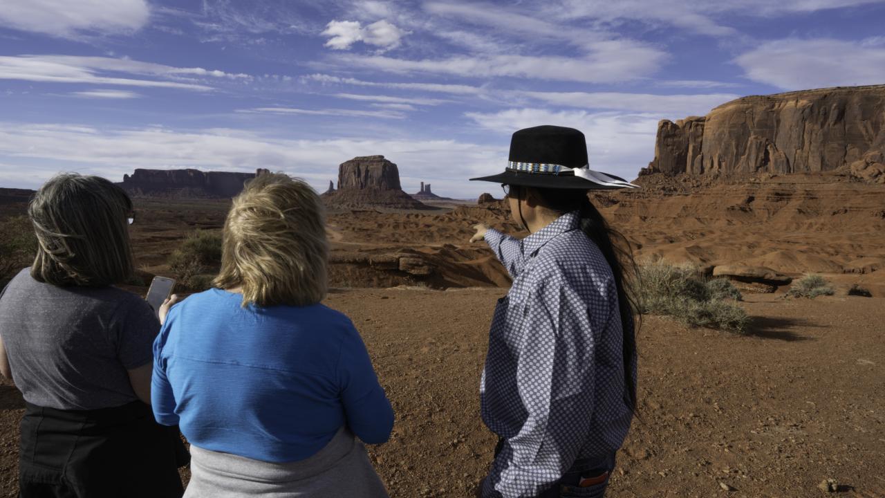 A tribal tour guide showing tourists around. 