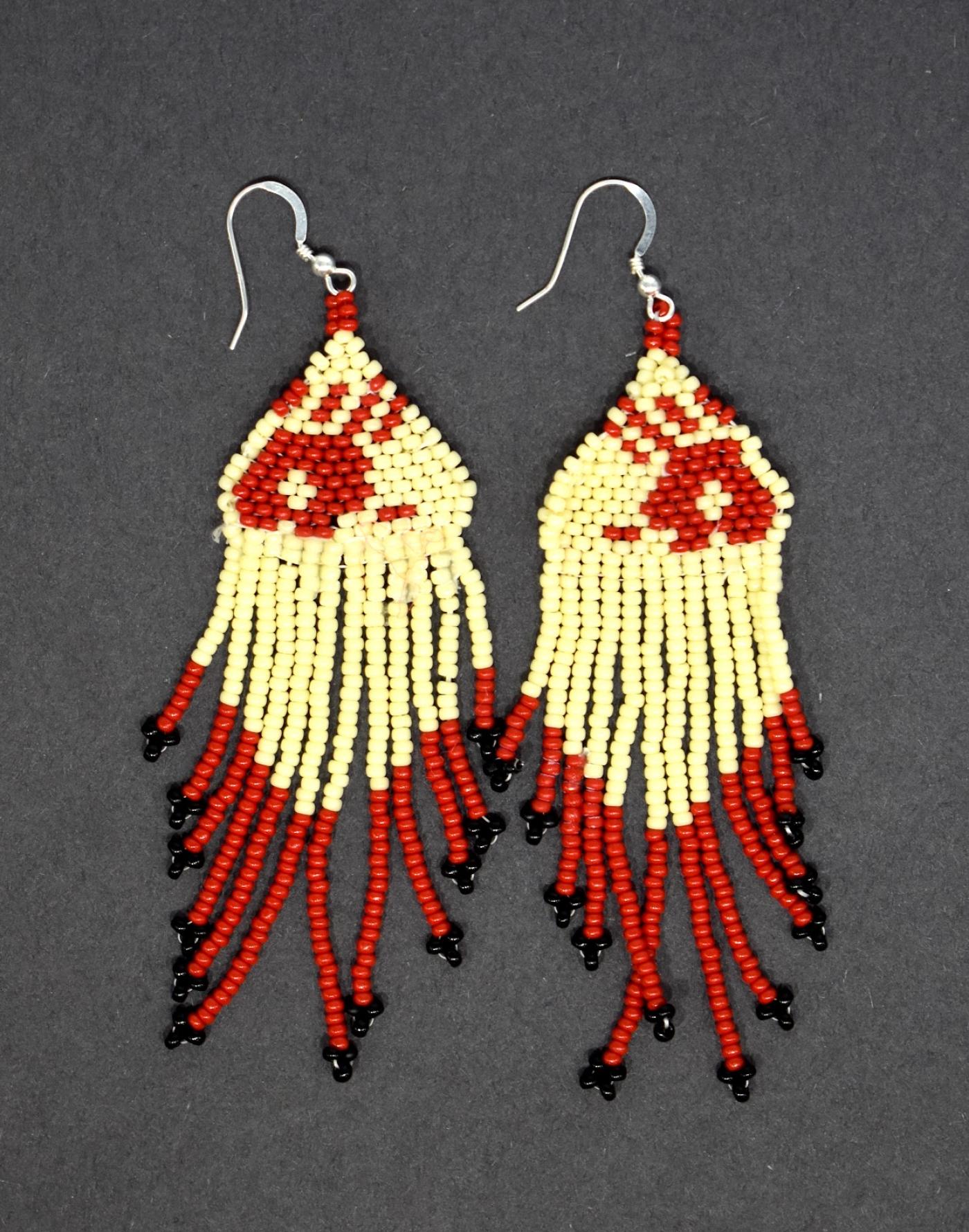 Beadwork earrings with beaded tassels depicting red handprints. 