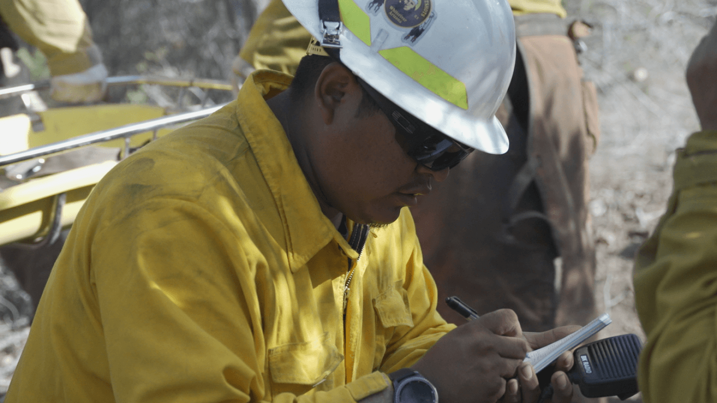 A firefighter takes notes.