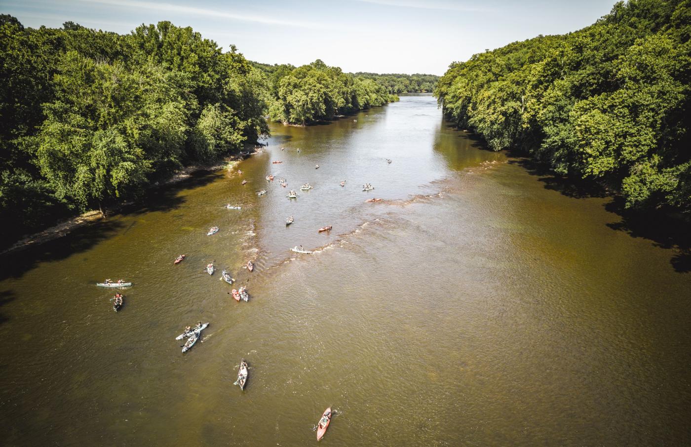Drone image of students kayaking over an ancient Indigenous fishing weir on the Potomac River