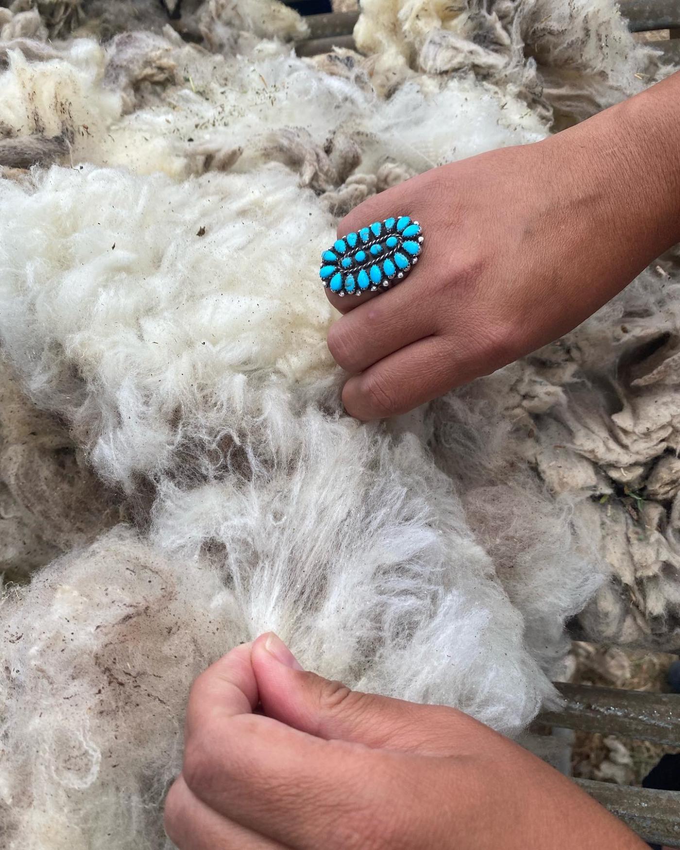 Hands Stretching Raw Wool